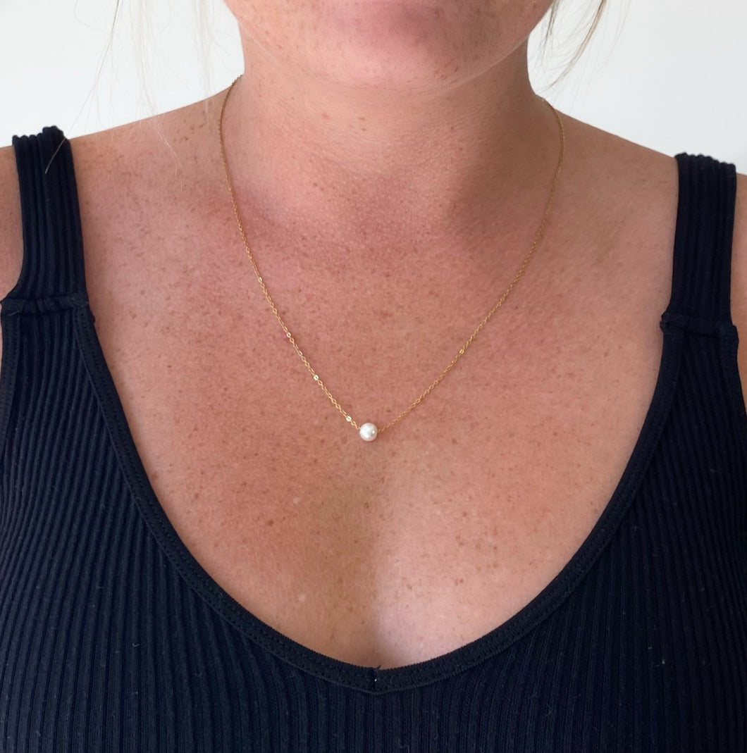 Dainty gold necklace with single pearl