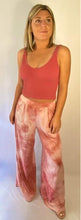 Load image into Gallery viewer, Model wearing pink and white tie dye wide leg pants paired with a pink cropped tank top
